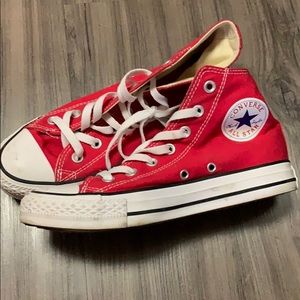 Red Converse high top Chuck Taylors.